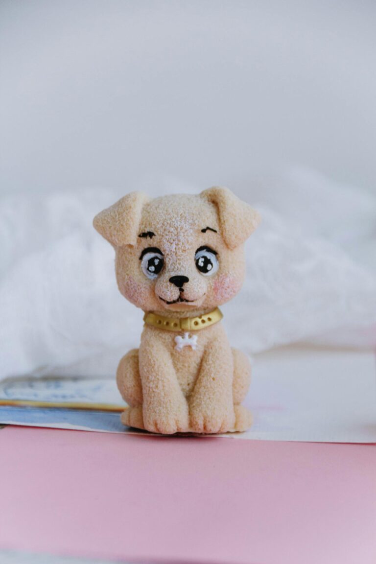 A charming handmade puppy figurine displayed on a soft pastel background, ideal for decoration.